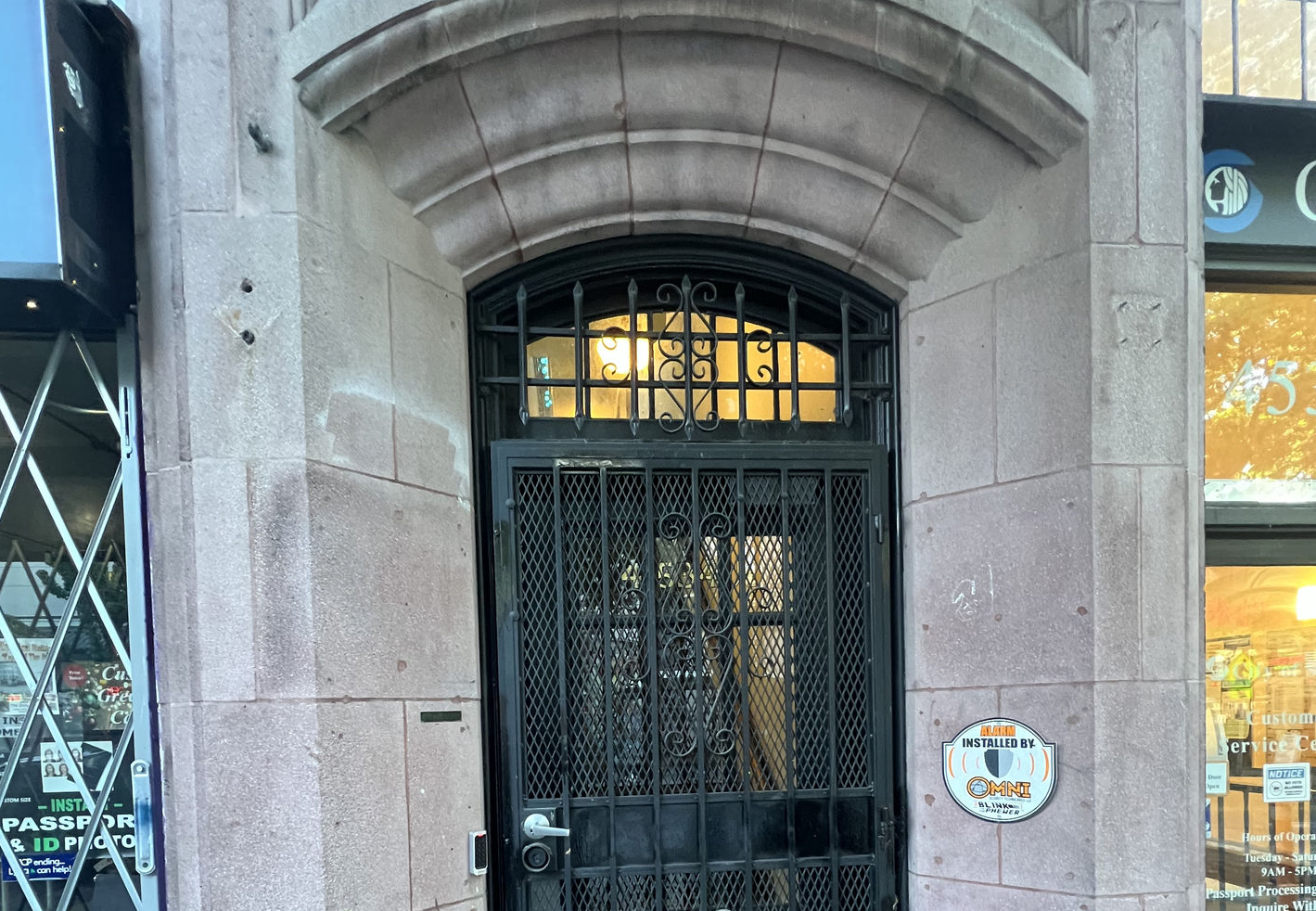 A black gate under a stone arch.